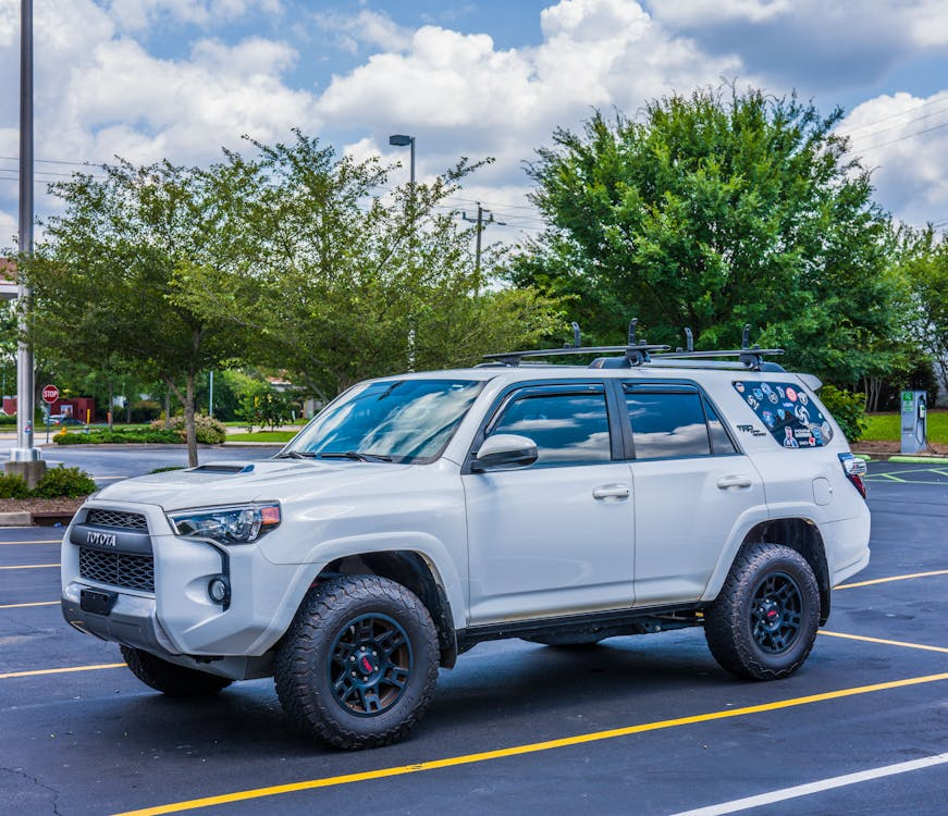 Modern SUV sizes example featuring a white Toyota 4Runner with off-road tires and roof rack