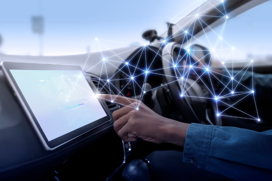 Driver interacting with touchscreen in connected car showing digital interface, illustrating core features of software-defined vehicles.