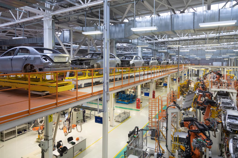 AI-powered automotive manufacturing line with robotic arms assembling car bodies on a smart factory floor.