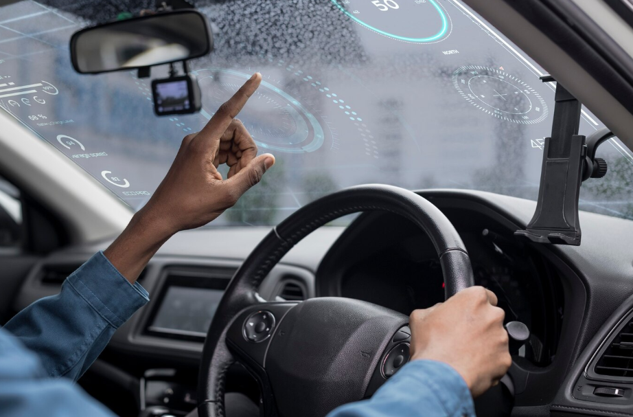 Driver interacting with a digital vehicle cockpit and software-defined vehicle technology dashboard using augmented reality HUD.