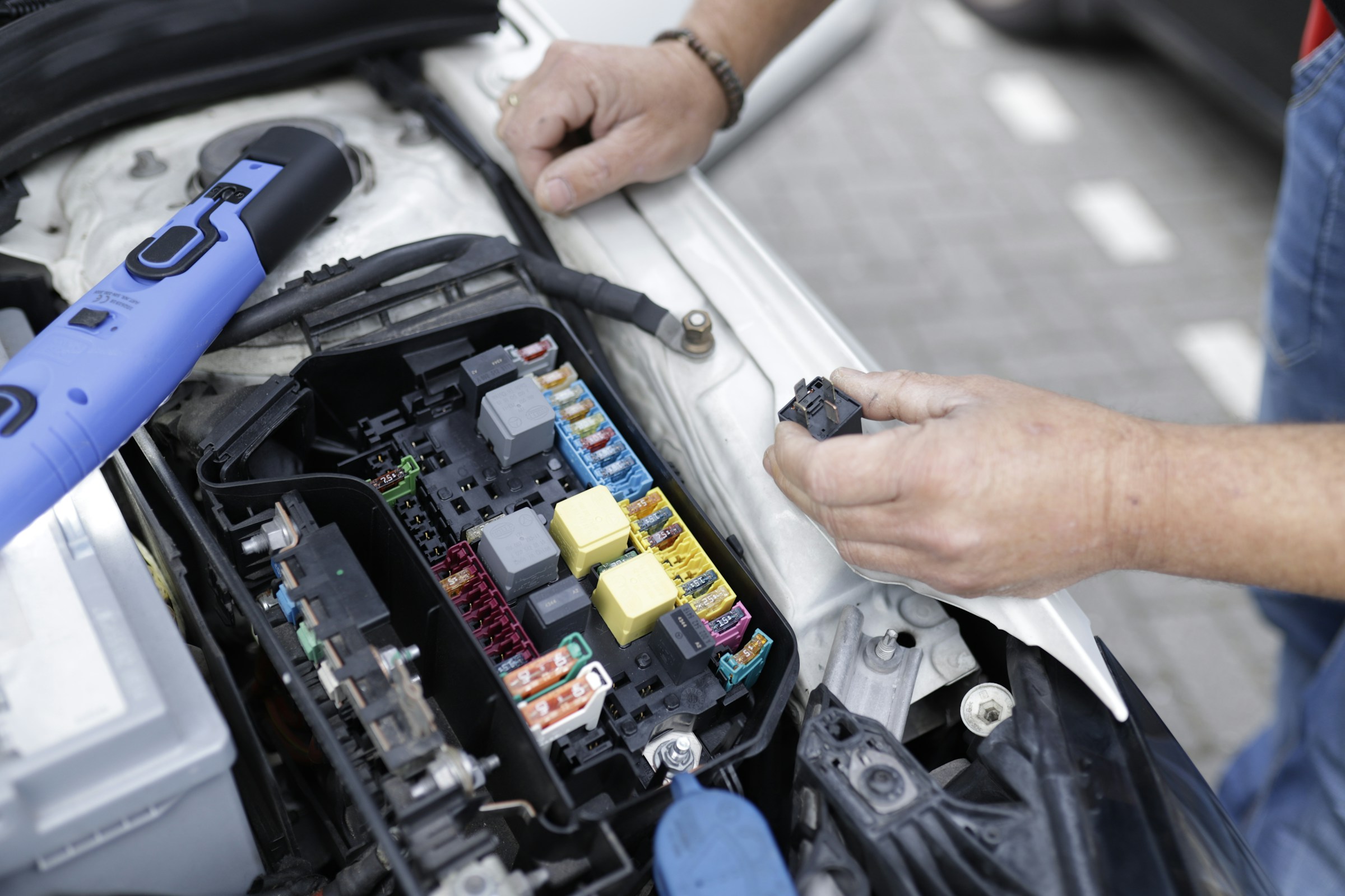 man working on a car's engine