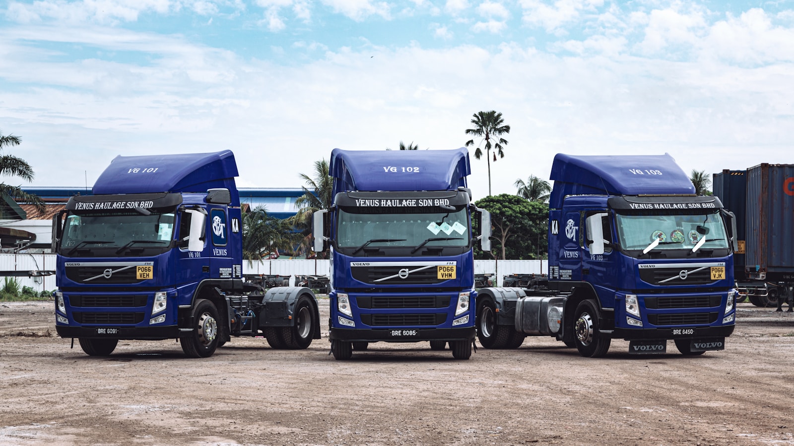 a couple of blue trucks parked next to each other